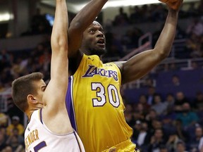 Los Angeles Lakers forward Julius Randle (30) goes up for a shot against Phoenix Suns forward Dragan Bender (35) during the first half of an NBA basketball game Monday, Nov. 13, 2017, in Phoenix. (AP Photo/Ross D. Franklin)