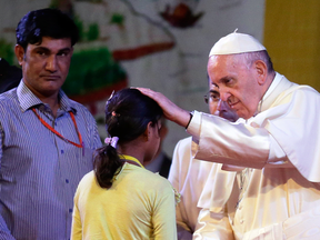 Pope Francis meets a young Rohingya Muslim refugee at an interfaith peace meeting in Dhaka, Bangladesh, Friday, Dec. 1, 2017.