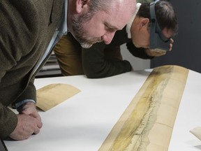 In this Friday, Nov. 10, 2017 photo American Revolution Museum's Philip Mead, left, chief historian, along with Scott Stephenson, vice president of collections, exhibitions and programming view a recently discovered painting offering a glimpse into the Revolutionary War, in Philadelphia. The watercolor panorama of a Continental Army encampment features the only known wartime depiction of George Washington's headquarters tent, his command center throughout the war. The tent is also the marquee exhibit at the museum, which opened in April in Philadelphia. (AP Photo/Matt Rourke)
