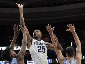 Villanova's Mikal Bridges (25) goes up for a shot between Columbia's Rodney Hunter (4) and Gabe Stefanini (15) during the first half of an NCAA college basketball game, Friday, Nov. 10, 2017, in Philadelphia. (AP Photo/Matt Slocum)