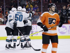 San Jose Sharks' Chris Tierney (50) celebrates with his teammates past Philadelphia Flyers' Danick Martel (70) after Tierney scored a goal during the first period of an NHL hockey game, Tuesday, Nov. 28, 2017, in Philadelphia. (AP Photo/Matt Slocum)