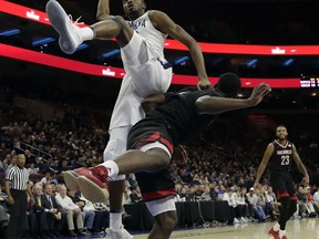 Villanova's Mikal Bridges, top, is fouled by Nicholls State's Tevon Saddler during the first half of an NCAA college basketball game, Tuesday, Nov. 14, 2017, in Philadelphia. (AP Photo/Matt Slocum)