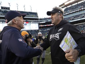 Chicago Bears head coach John Fox, left, and Philadelphia Eagles head coach Doug Pederson meet after an NFL football game, Sunday, Nov. 26, 2017, in Philadelphia. Philadelphia won 31-3. (AP Photo/Michael Perez)