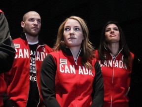 Sarah Reid (centre) and Mellisa Hollingsworth (right) benefited Wednesday from the banishment of three Russian skeleton racers by the IOC. Reid now goes down as the fourth-place finisher in at the Sochi OIympics in 2014.