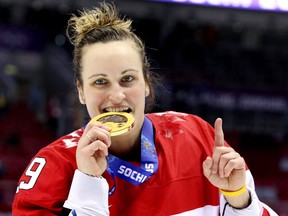 In this Feb. 20, 2014 file photo, Canadian forward Marie-Philip Poulin celebrates with her gold medal at the Sochi Olympics.