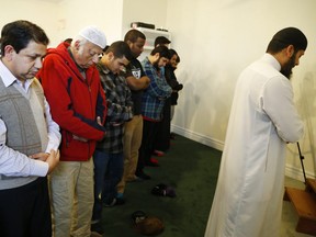 Members attend a prayer service led by Imam Shazim Khan inside the newly renovated Masjid Al-Salaam Mosque on Wednesday December 23, 2015 in Peterborough, Ont.
