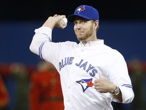 In this April 4, 2014 file photo, Roy Halladay throws the ceremonial first pitch at the Toronto Blue Jays' season opener.