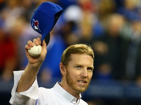 In this April 4, 2014 file photo, Roy Halladay salutes the crowd at the Toronto Blue Jays' season opener.