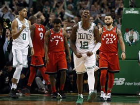 Boston Celtics forward Jayson Tatum (0) and guard Terry Rozier (12) celebrate their win over the Toronto Raptors on Nov. 12.