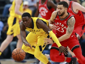 Indiana Pacers guard Darren Collison, left, and Toronto Raptors counterpart Fred VanVleet chase the ball during the first half of their game, Friday night in Indianapolis. The Pacers won 107-104.