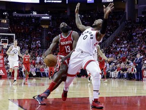 Rockets guard James Harden loses the ball as he collides with Toronto Raptors forward CJ Miles on a drive to the basket during the second half of their game Tuesday night in Houston.