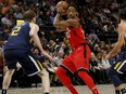 DeMar DeRozan of the Toronto Raptors looks to make a play with the ball while being defended by Joe Ingles of the Utah Jazz during NBA action Friday in Salt Lake City. DeRozan had 37 points to pace the Raptors to a 109-100 victory.