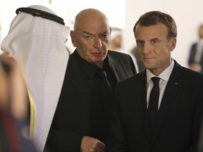 Project designer French architect Jean Nouvel, center, and French President Emmanuel Macron attend the inauguration of the Louvre Abu Dhabi Museum in Abu Dhabi, United Arab Emirates, Wednesday, Nov. 8, 2017. (Ludovic Marin/Pool photo via AP)