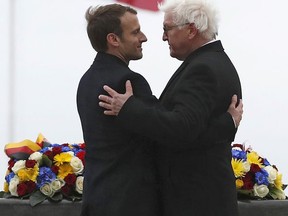 French President Emmanuel Macron, left, and German President Frank-Walter Steinmeier left, attend a commemoration ceremony at the World War I Vieil Armand "Hartmannswillerkopf" battlefield in the Alsace region, eastern France, where around 30,000 French and German soldiers died in the Vosges mountain battles in 1915, Friday, Nov. 10, 2017. The presidents of France and Germany say Europeans must stand up to nationalism and build a "common future," as they mark 99 years since the armistice ending World War I. (Christian Hartmann/Pool Photo via AP)