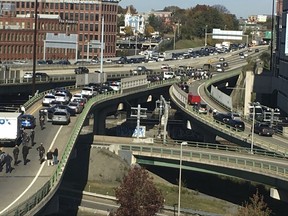 Police congregate on a highway on a ramp near the Providence Place Mall amid reports of a shooting, Thursday, Nov. 9, 2017, in Providence, R.I. (Lisa Newby/Providence Journal via AP)