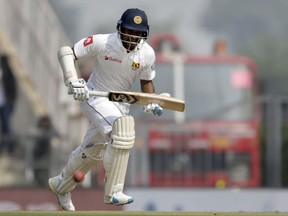 Sri Lanka's Dimuth Karunaratne runs between the wickets after playing a shot during the first day of their second test cricket match against India in Nagpur, India, Friday, Nov. 24, 2017. (AP Photo/Rajanish Kakade)