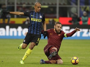 FILE - In this Sunday, Feb. 26, 2017 file photo, Roma's Daniele De Rossi, right, and Inter Milan's Joao Mario vie for the ball during an Italian Serie A soccer match between Inter Milan and Roma, at the San Siro stadium in Milan, Italy. For all his leadership qualities, Daniele De Rossi still can't shake his tendency to overreact to physical contact. The Roma midfielder's slap to the face of Genoa's Gianluca Lapadula over the weekend was the latest in a long line of undisciplined behavior. (AP Photo/Luca Bruno, File)