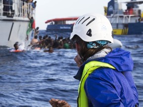 A migrant's hand is seen as member of a German nonprofit organisation looks at other migrants trying to board a Libyan coast guard ship after being rescued at sea, Monday, Nov. 6, 2017. Five migrants have died as a German nonprofit organization, Sea-Watch, and the Libyan coast guard tried to rescue them from their foundering boat in the Mediterranean, with each side blaming the other for botching the operation. (Lisa Hoffmann/Sea-Watch via AP)