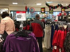 Shoppers look for merchandise on sale at the Garden State Plaza on Saturday, Nov. 25, 2017, in Paramus, N.J.  At the Garden State Plaza, where parking lots were full, J.C. Penney was offering store-wide sales like up to 40 percent off on major appliances and on women's clothing. The chain was also trying to make shopping in person more exciting, with a DJ in the store. (AP Photo/Anne D'Innocenzio)