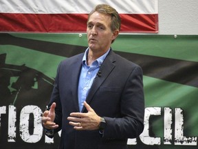 U.S. Sen. Jeff Flake, R-Ariz., speaks to aerospace workers about the current congressional tax reform proposal in Mesa, Ariz., Friday, Nov. 17, 2017. The Republican told aerospace company workers that corporate tax cuts are needed to restore America's global competitiveness. (AP Photo/Bob Christie)