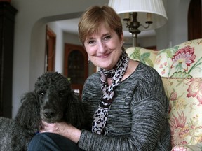 In this Nov. 14, 2017 photo, Ellie Mixter-Keller poses for a photo with her dog at her home in Wauwatosa, Wis. Mixter-Keller, 62, says she knew the dangers of smoking. She smoked a pack a day for 30 years before quitting 12 years ago. Under a court order, the largest U.S. tobacco companies will be forced to advertise the deadly addictive effects of smoking starting the week of Nov. 26. This comes more than a decade after a judge ruled that the industry had misled the public about the risks of cigarettes. (AP Photo/Carrie Antlfinger)