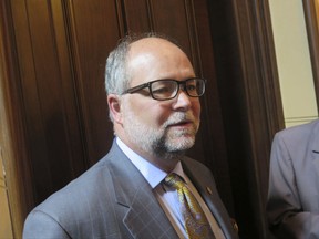 In this June 6, 2017 photo, Michigan Senate Majority Leader Arlan Meekhof speaks with reporters at the State Capitol in Lansing, Mich. The Republican is sponsoring fast-tracked legislation that would let gun owners carry concealed weapons inside schools and other gun-free zones. (AP Photo/David Eggert)
