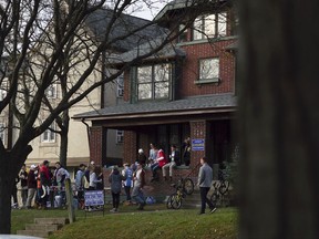 In this Friday, Nov. 17, 2017 photo, students listen to music and drink at an outdoor party at Ohio State University in Columbus, Ohio. Ohio State has joined a growing list of schools hitting pause on Greek life as they grapple with how to prevent hazing, alcohol misuse and other misconduct. (AP Photo/Dake Kang)