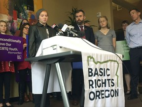 Elliot Yoder, 16, a transgender student at Dallas High School in Dallas, Ore., speaks at a news conference held by ACLU Oregon and Basic Rights in Portland, Ore., Thursday, Nov. 16, 2017, to protest a federal lawsuit filed against the Dallas School District over its policy on the treatment of transgender students. The district began allowing Yoder to use the boys' locker room and boys' restrooms after he publicly identified as transgender. (AP Photo/Gillian Flaccus)