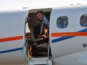University of Florida's new NCAA college football coach Dan Mullen smiles as he arrives at the airport in Gainesville, Fla., Monday, Nov. 27, 2017. (AP Photo/Mark Long)