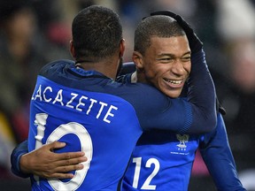France's scorer Alexandre Lacazette, left, and his teammate Kylian Mbappe, right, celebrate their side's 2nd goal during an international friendly soccer match between Germany and France in Cologne, Germany, Tuesday, Nov. 14, 2017. (AP Photo/Martin Meissner)