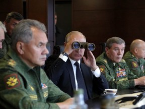 Russian President Vladimir Putin watches a military exercise at a training ground at the Luzhsky Range, near St. Petersburg, Russia, Monday, Sept. 18, 2017. The Zapad (West) 2017 maneuvers have caused concern among some NATO members neighbouring Russia, who have criticized a lack of transparency about the exercises and questioned Moscow's real intentions.