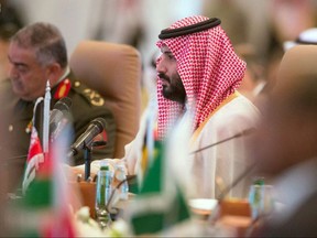 In this photo released by the state-run Saudi Press Agency, Saudi Crown Prince Mohammed bin Salman speaks at a meeting of the Islamic Military Counterterrorism Alliance in Riyadh, Saudi Arabia, Sunday, Nov. 26, 2017. Saudi Arabia's assertive crown prince on Sunday opened the first high-level meeting of a kingdom-led alliance of Muslim nations against terrorism, vowing that extremists will no longer "tarnish our beautiful religion." (Saudi Press Agency via AP)