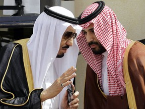 FILE - In this May 14, 2012 file photo, King Salman, left, speaks with his son, now Crown Prince Mohammed Bin Salman, (MBS), as they wait for Gulf Arab leaders ahead of the opening of Gulf Cooperation Council, in Riyadh, Saudi Arabia. The surprise dismissal and arrest of dozens of ministers, royals, officials and senior military officers by MBS late Saturday, Nov. 4, 2017, is unprecedented in the secretive, 85-year-old kingdom. But so is the by-now virtually certain rise to the throne of a 30-something royal who, in another first, is succeeding his father. (AP Photo/Hassan Ammar, File)