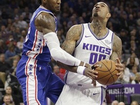 Sacramento Kings center Willie Cauley-Stein, right, is fouled by Philadelphia 76ers forward Robert Covington during the first quarter of an NBA basketball game Thursday, Nov. 9, 2017, in Sacramento, Calif. (AP Photo/Rich Pedroncelli)