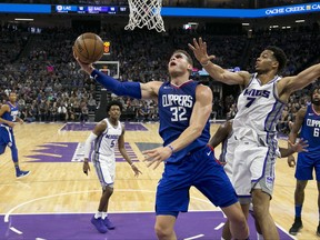 Los Angeles Clippers forward Blake Griffin, front left, goes to the basket against Sacramento Kings forward Skal Labissiere during the first quarter of an NBA basketball game Saturday, Nov. 25, 2017, in Sacramento, Calif. (AP Photo/Rich Pedroncelli)