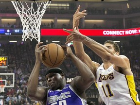 Sacramento Kings forward Zach Randolph, center, grabs a rebound between Los Angeles Lakers' Lonzo Ball, left, and Brook Lopez during the first quarter of an NBA basketball game Wednesday, Nov. 22, 2017, in Sacramento, Calif. (AP Photo/Rich Pedroncelli)