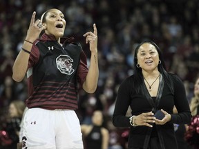 South Carolina forward A'ja Wilson, left, and head coach Dawn Staley celebrate after receiving their national championship rings before an NCAA college basketball game Friday, Nov. 10, 2017, in Columbia, S.C. (AP Photo/Sean Rayford)