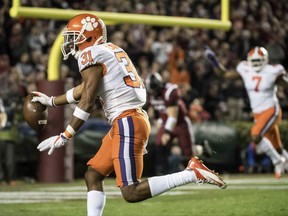 Clemson cornerback Ryan Carter (31) scores a touchdown after intercepting a pass against South Carolina during the first half of an NCAA college football game Saturday, Nov. 25, 2017, in Columbia, S.C. (AP Photo/Sean Rayford)