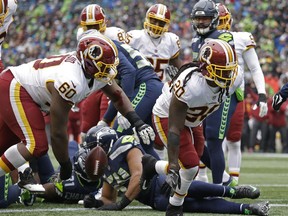 Washington Redskins running back Rob Kelley (20) gets up after he scored a 1-yard rushing touchdown against the Seattle Seahawks in the first half of an NFL football game, Sunday, Nov. 5, 2017, in Seattle. (AP Photo/Elaine Thompson)