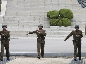 North Korean soldiers march during a visit by Australian Defense Minister Marise Payne and Foreign Minister Julie Bishop to the border village of Panmunjom in Paju, South Korea Oct. 12, 2017. South Korea says North Korean soldiers shot at and injured a fellow soldier who was crossing a border village to defect to the South. day, Nov. 13, 2017.