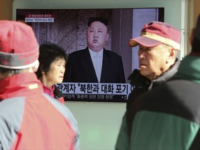 People watch a TV screen showing an image of North Korean leader Kim Jong Un at Seoul Railway Station in Seoul, South Korea, Tuesday, Nov. 21, 2017. U.S. President Donald Trump announced Monday the U.S. is putting North Korea's "murderous regime" on America's terrorism blacklist, despite questions about Pyongyang's support for international attacks beyond the assassination of its leader's half brother in February. The signs read "Give up conversation with North Korea." (AP Photo/Ahn Young-joon)