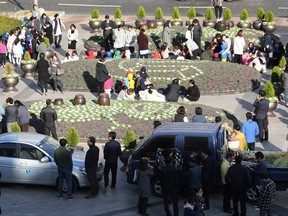 CORRECTION CORRECTS MAGNITUDE: People gather outside after evacuating Ulsan City Hall after an earthquake in Ulsan, South Korea, Wednesday, Nov. 15, 2017. A 5.4-magnitude earthquake struck off South Korea's southeastern coast Wednesday afternoon, but no casualties were immediately reported.(Lee Sang-hyun/Yonhap via AP)