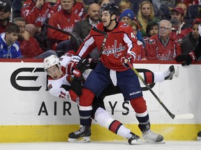 Mark Stone of the Ottawa Senators falls against the boards next to the Capitals' Tom Wilson during the first period on Wednesday night in Washington.
