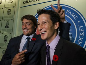Former teammates Teemu Selanne, left, and Paul Kariya share a chuckle at the Hockey Hall of Fame in Toronto. The two were among seven formally enshrined into the hall on Monday night.