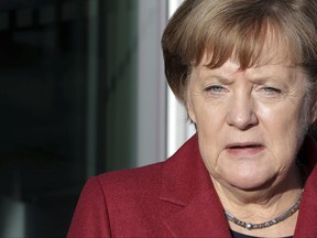 German Chancellor and chairwoman of the German Christian Democratic Union (CDU), Angela Merkel, addresses the media as she arrives for exploratory talks on a coalition between the CDU, the Christian Social Union (CSU), the German Liberal Party (FDP) and the Green Party in Berlin, Germany, Friday, Nov. 17, 2017. (AP Photo/Michael Sohn)