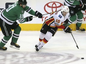 Martin Hanzal, left, of the Dallas Stars, uses his stick trying to impede Kris Versteeg of the Calgary Flames during NHL action Friday night in Dallas. The Stars were 6-4 winners.