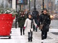 Snow falls on Yonge St. in Toronto on Dec. 11, 2016.