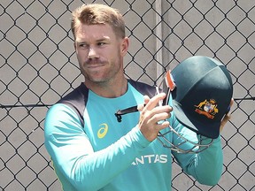 Australian cricket player David Warner leaves the nets during a training session in Brisbane, Australia, Tuesday, Nov. 21, 2017. Warner is confident he'll overcome a painful neck strain in time to play for Australia in the Ashes series opener against England on Thursday. (Jono Searle/AAP Image via AP)
