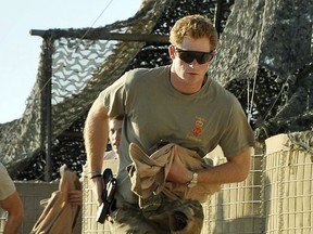 FILE - In this Nov. 3 2012 file photo, Britain's Prince Harry or just plain Captain Wales as he is known in the British Army, races out from the VHR (very high ready-ness) tent to scramble his Apache with fellow Pilots, during his 12 hour shift at the British controlled flight-line in Camp Bastion southern Afghanistan. Palace officials announced Monday Nov. 27, 2017, Prince Harry and Meghan Markle are engaged, and will marry in the spring. (AP Photo/ John Stillwell, File)