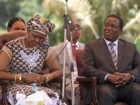 FILE - In this Wednesday Feb, 10, 2016 file photo, Zimbabwean first lady Grace Mugabe, left, sits next to vice President Emmerson Mnangagwa at the Zanu pf headquarters in Harare. (AP Photo/Tsvangirayi Mukwazhi, File)